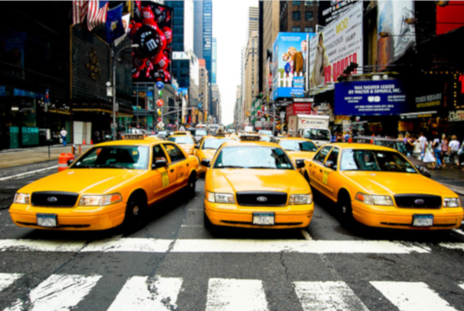Multiple Taxi Cars In Busy Town